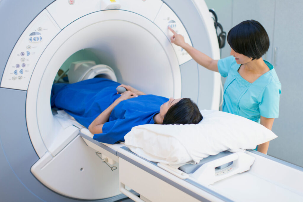 technician putting patient into MRI scanner